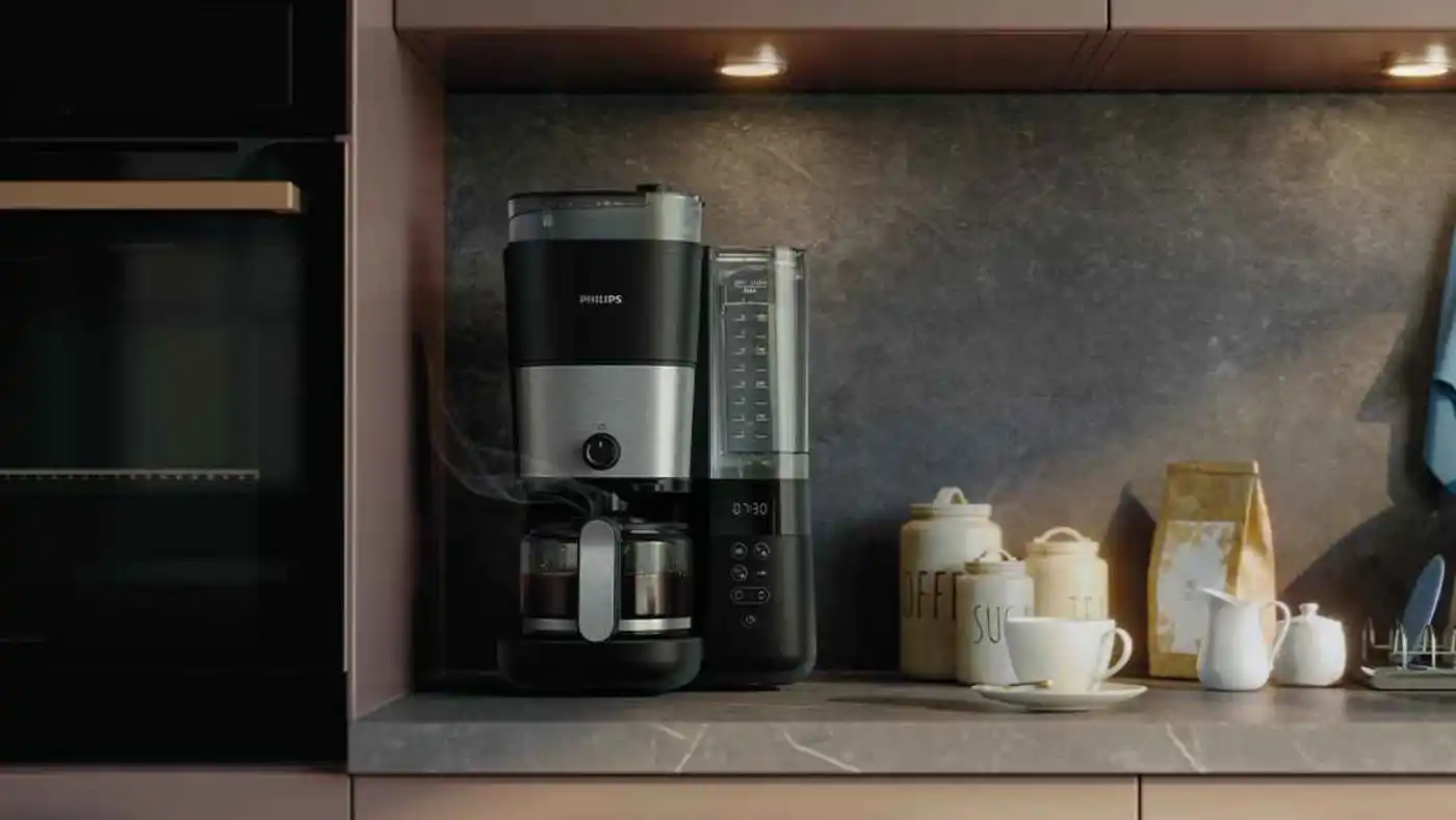 Coffee-14-fi Philips kafijas automāts ar automātiskajām dzirnaviņām un taimeri stilīgā virtuvē. Melns un sudrabkrāsas dizains, pildās stikla kanna. Izbaudiet svaigi pagatavotu kafiju.