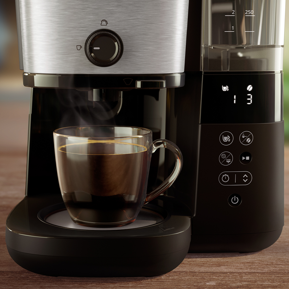 Drip-filter-11- Philips Drip filtrkafijas automāta tuvplāns ar caurspīdīgu krūzīti, kurā izceļas kafijas pagatavošana, digitālais taimeris un sildvirsma. Tas izceļ bagātīgo aromātu.