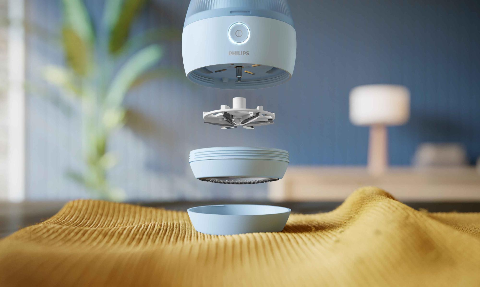 Philips Essentials Garment Care auduma skuveklis, izjaukts, lai uz džempera parādītu savārstījuma tīrīšanas sastāvdaļas. Šis savārstījuma tīrīšanas līdzeklis efektīvi atjauno vecus apģērbus.