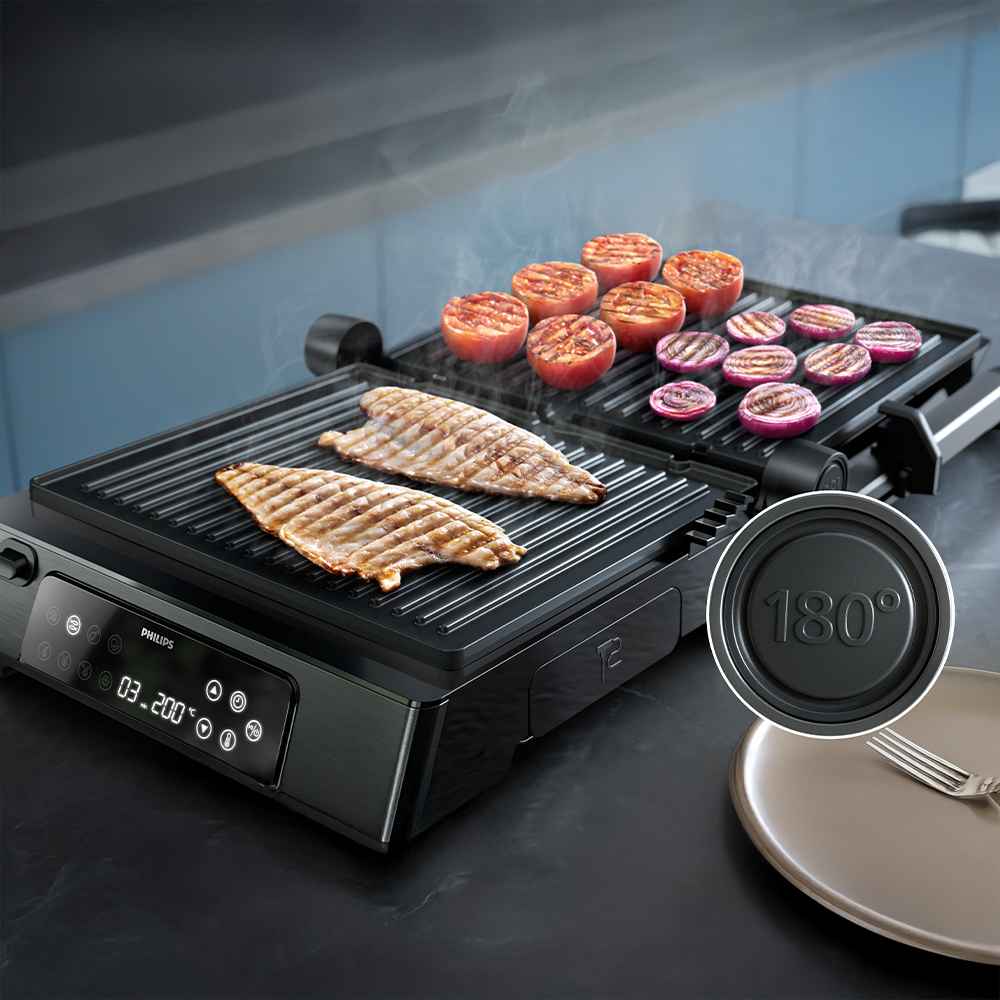 Philips grilu un tosteru līnija: atvērts elektriskais grils, kurā var baudīt zivis, tomātus un sīpolus. Digitālais displejs izceļ temperatūras kontroli un daudzpusību.