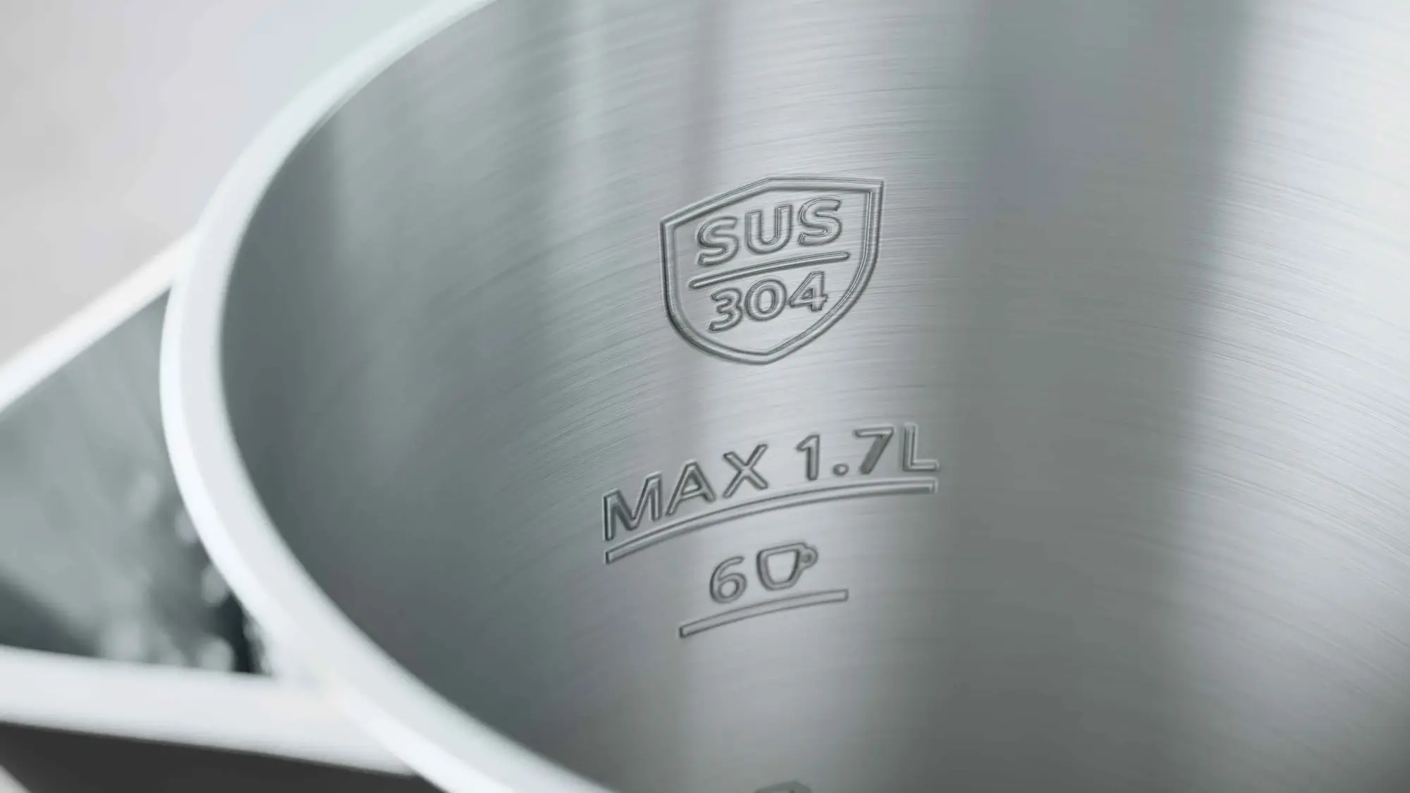 Philips Kettles produkta tuvplāns, kas demonstrē izcilu dizainu: matētā nerūsējošā tērauda iekšpusē ir MAX 1,7 l uzpildes atzīme un SUS 304 pārtikas kvalitātes nerūsējošā tērauda marķējums, kas nodrošina izcilu kvalitāti un drošību.