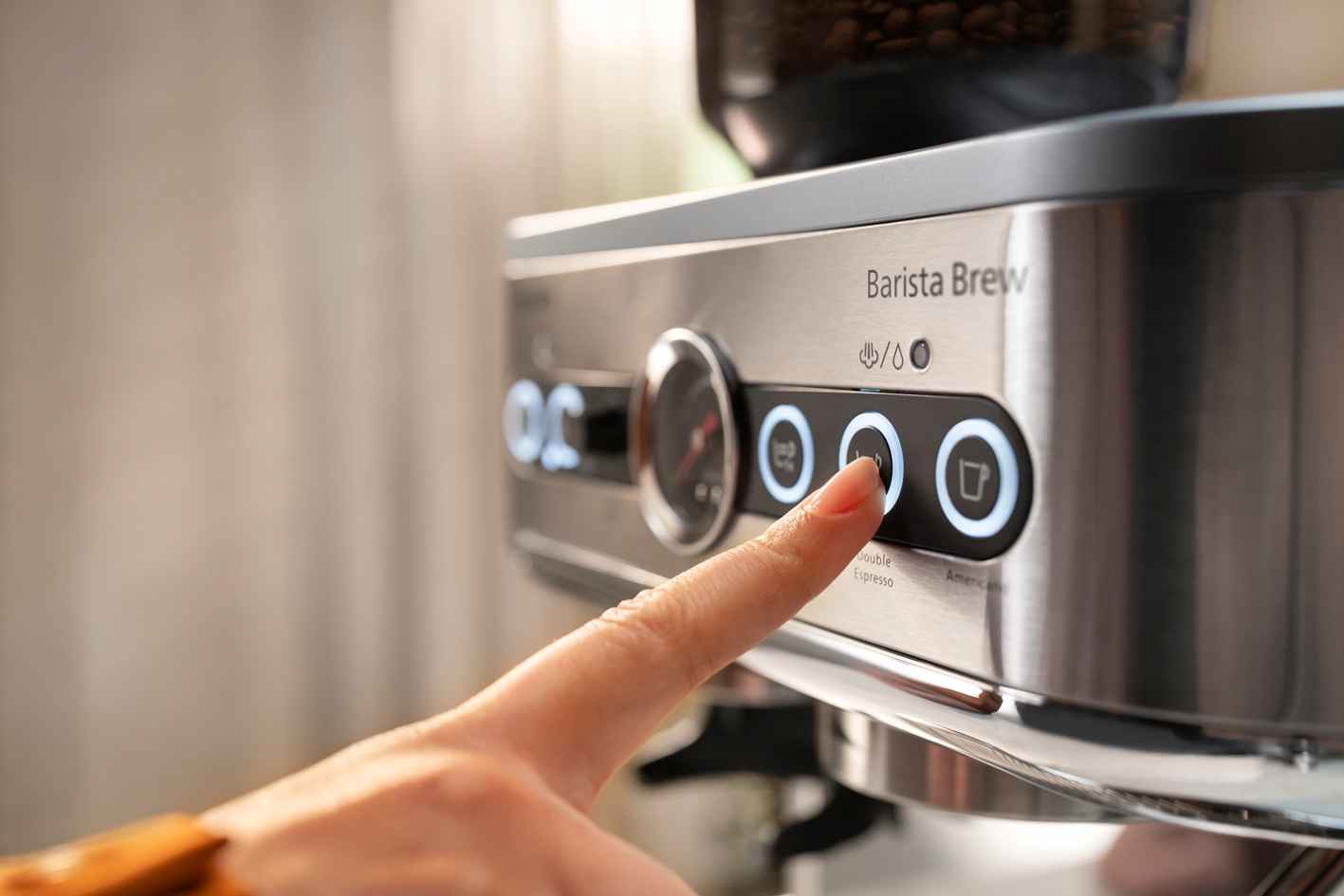 Philips pusautomātiskās kafijas automāta paneļa tuvplāns, kurā ar pirkstu, izmantojot skārienjutīgās pogas, tiek izvēlēta dubultās espreso opcija.