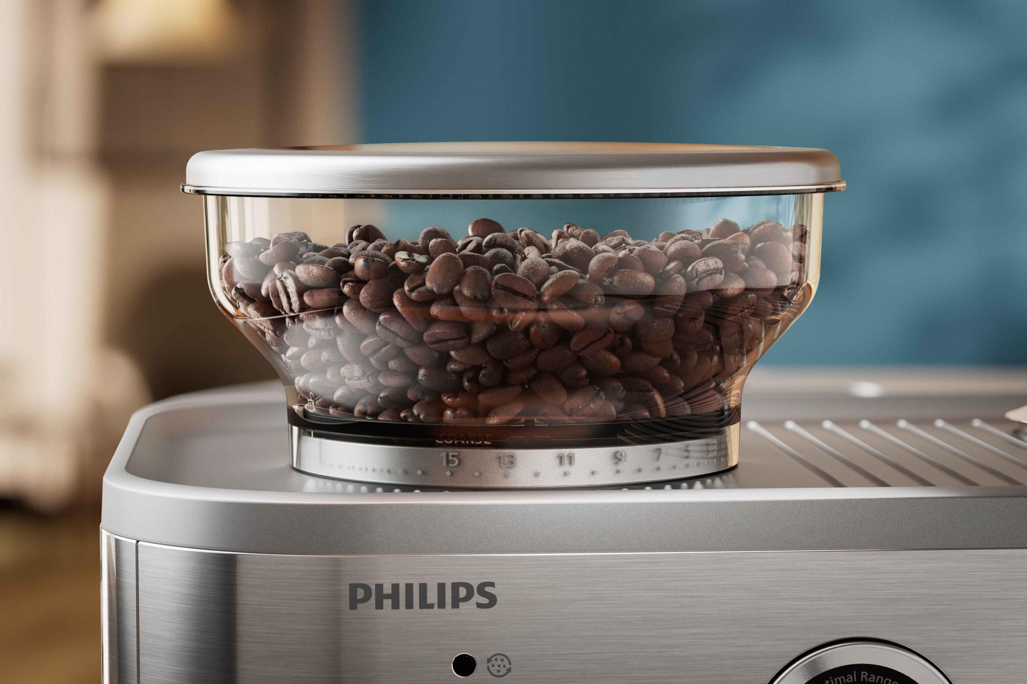 Philips pusautomātisko kafijas dzirnaviņu tuvplāns; regulējami maluma iestatījumi, caurspīdīga, ar pupiņām piepildīta tvertne nodrošina precizitāti un svaigu kafiju katru reizi.