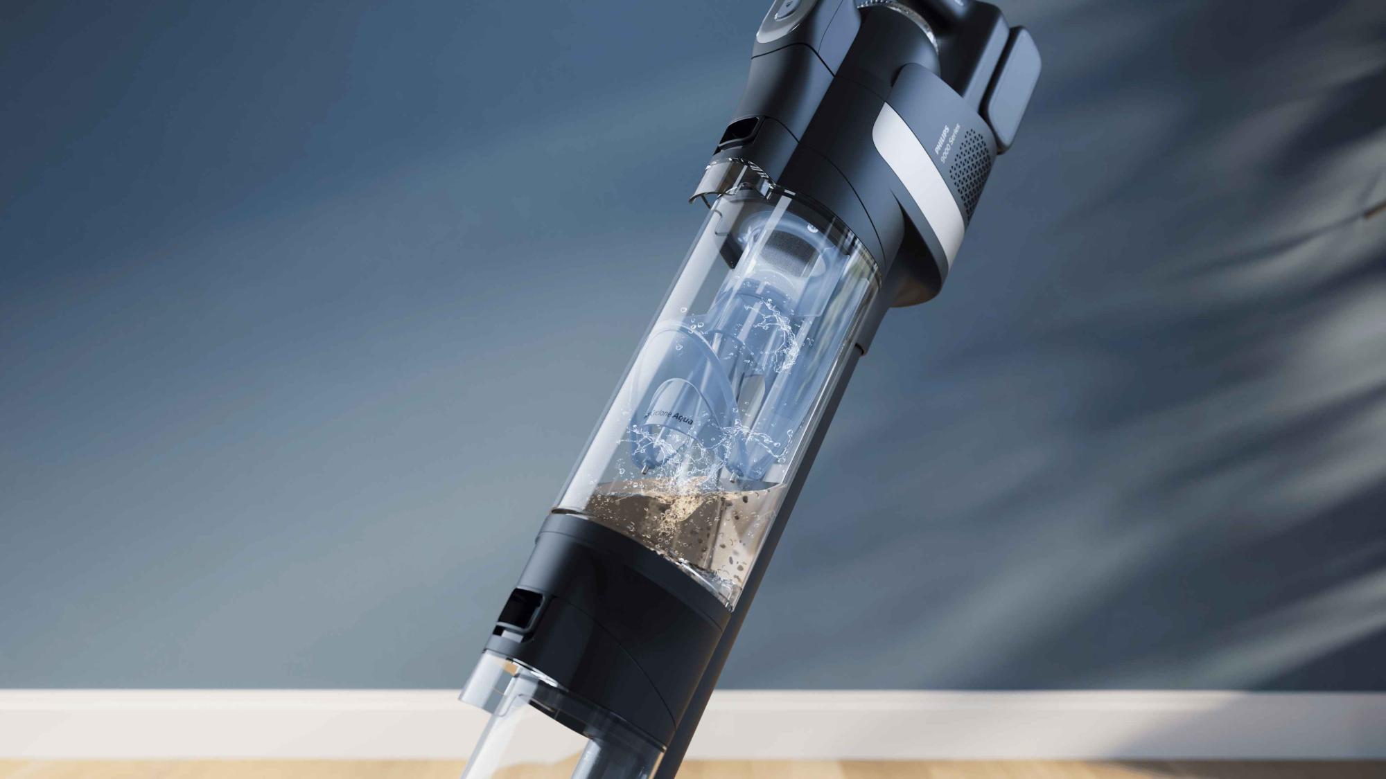 Philips Vac & Wash putekļsūcēja tuvplāns, kurā redzama tā jaudīgā sūkšanas un ūdens filtrācijas sistēma, kas noņem netīrumus no grīdām; apliecinājums inovatīvam dizainam.