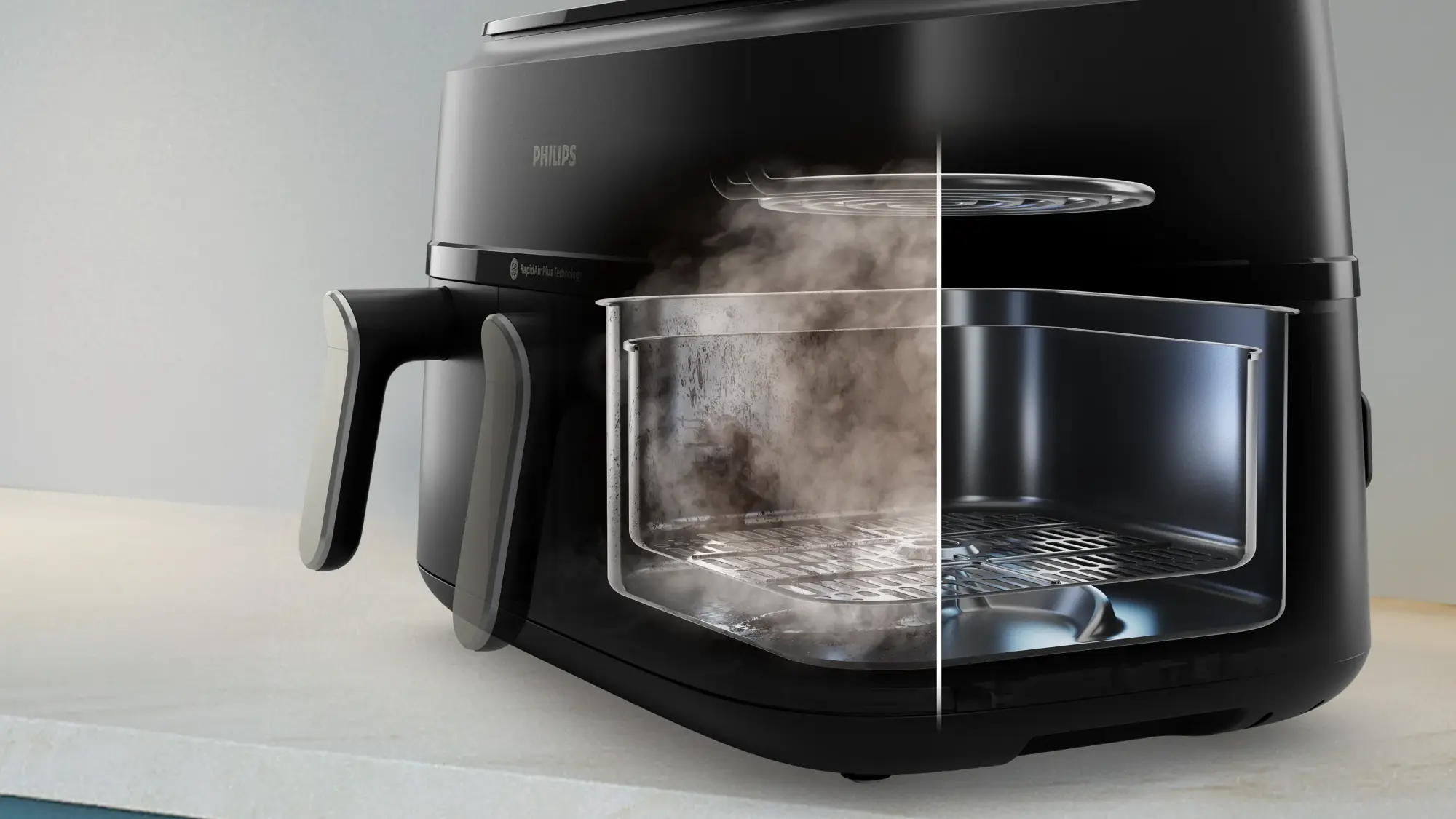 Uz letes novietots Philips divu grozu gaisa fritieri ar piederumiem un traukiem.